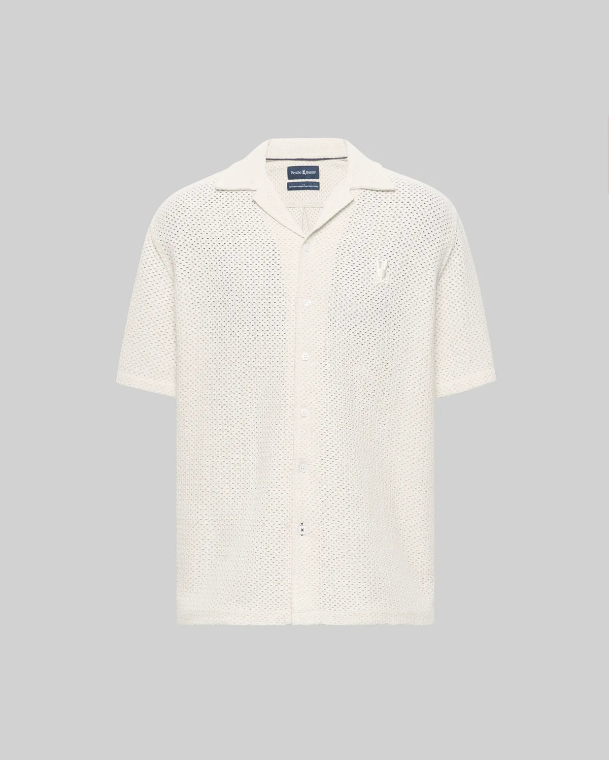 The Psycho Bunny MENS SAMMY CROCHET SHORT SLEEVE SHIRT (MT0300108) is an off-white, collared, button-up mesh shirt made from a semi-sheer cotton blend, shown on a plain gray background.