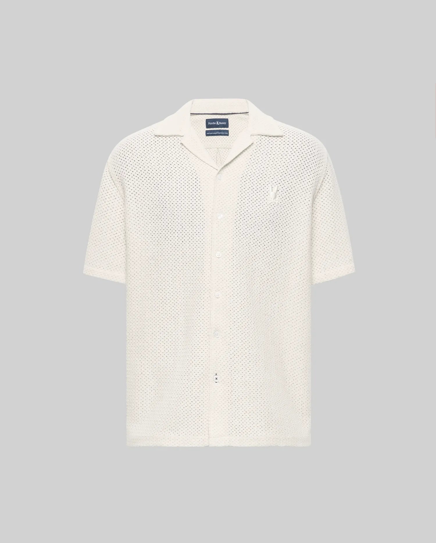 The Psycho Bunny MENS SAMMY CROCHET SHORT SLEEVE SHIRT (MT0300108) is an off-white, collared, button-up mesh shirt made from a semi-sheer cotton blend, shown on a plain gray background.