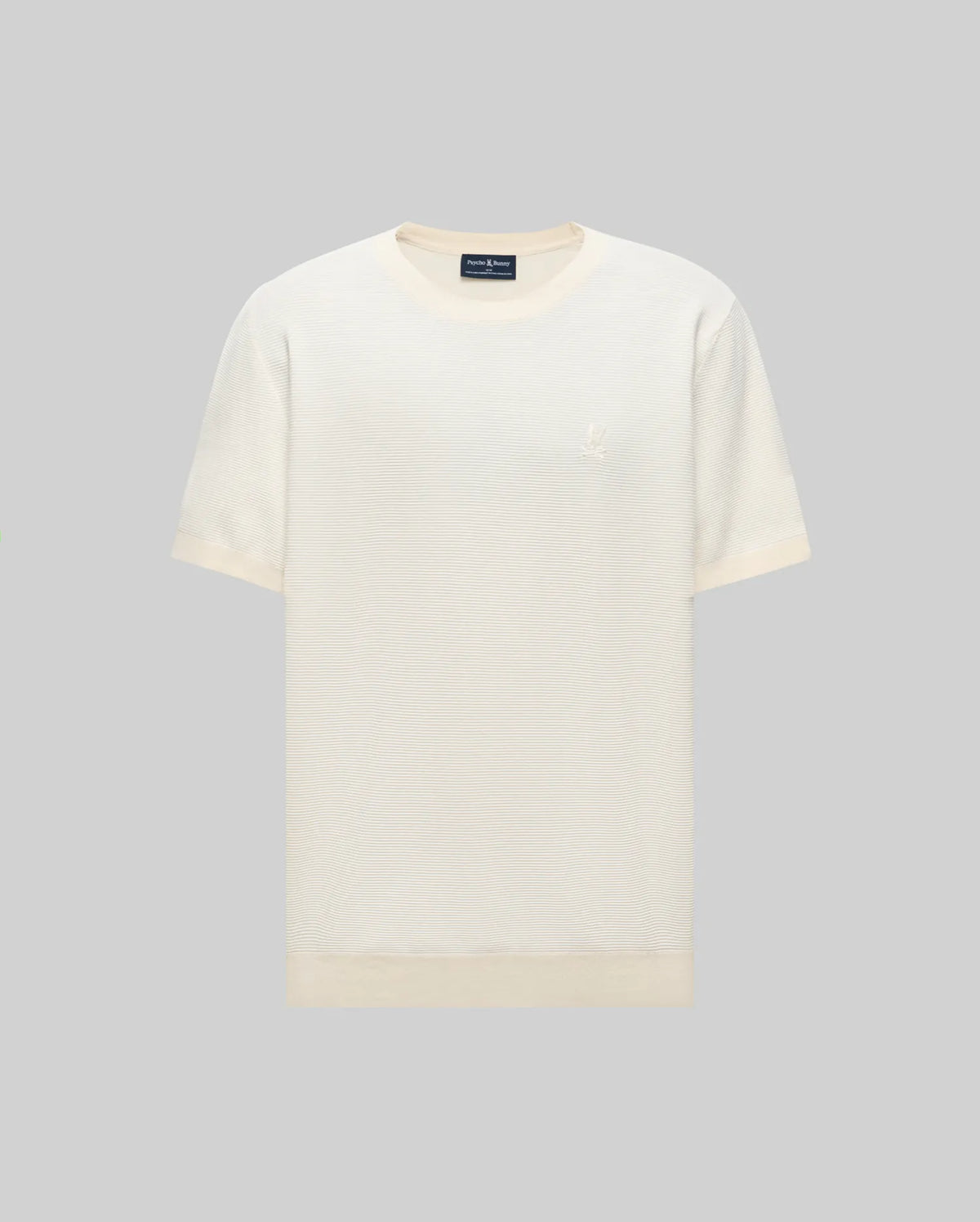 The Psycho Bunny MENS MARIO STRIPED SWEATER T-SHIRT (MT0400009) is a short-sleeved, off-white tee with a round neckline and a subtle embroidered logo on the left chest, displayed against a light gray background. Retro striped pattern adds style.