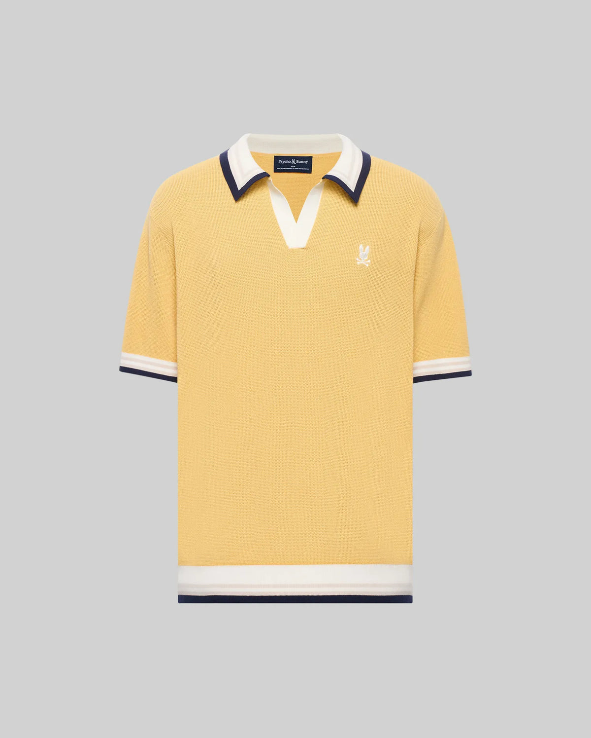 The Psycho Bunny MENS CARTER JOHNNY COLLAR KNIT POLO (MT0400093) is a yellow short-sleeve 100% cotton shirt with a white and navy Johnny collar, chest logo embroidery, and matching sleeve and hem trim, shown on a gray background.