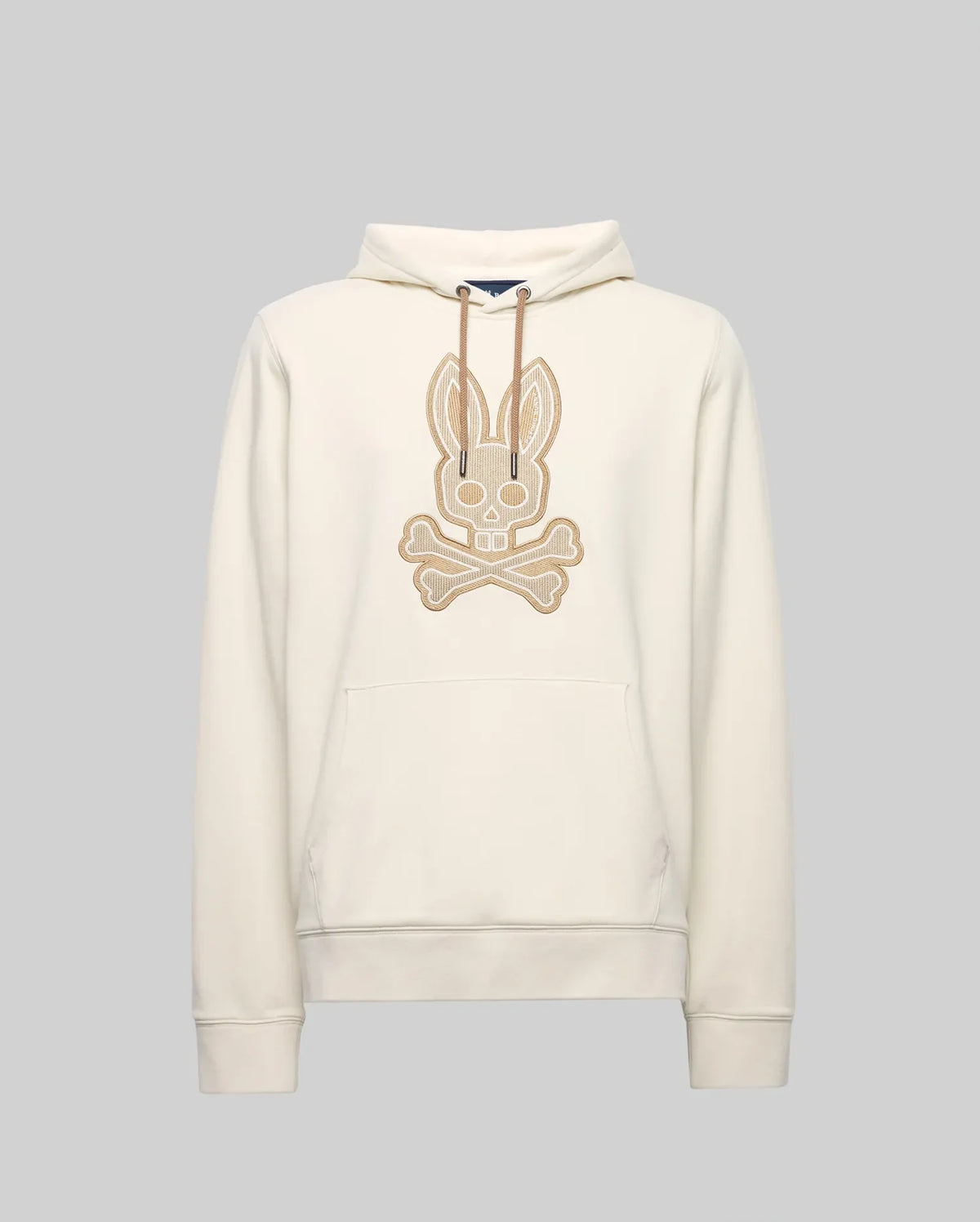 The Psycho Bunny MENS RYDER EMBROIDERED BUNNY PATCH HOODIE (MT0500029) is a cream-colored hoodie with a front pocket, drawstring hood, and large embroidered bunny skull and crossbones patch—ideal for cozy loungewear style.