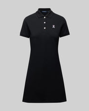 The WOMENS POLO DRESS - WO2000003 by Psycho Bunny is a black Pima polo dress with a collar, three white buttons, and a small white Bunny logo on the chest, shown on a plain gray background.
