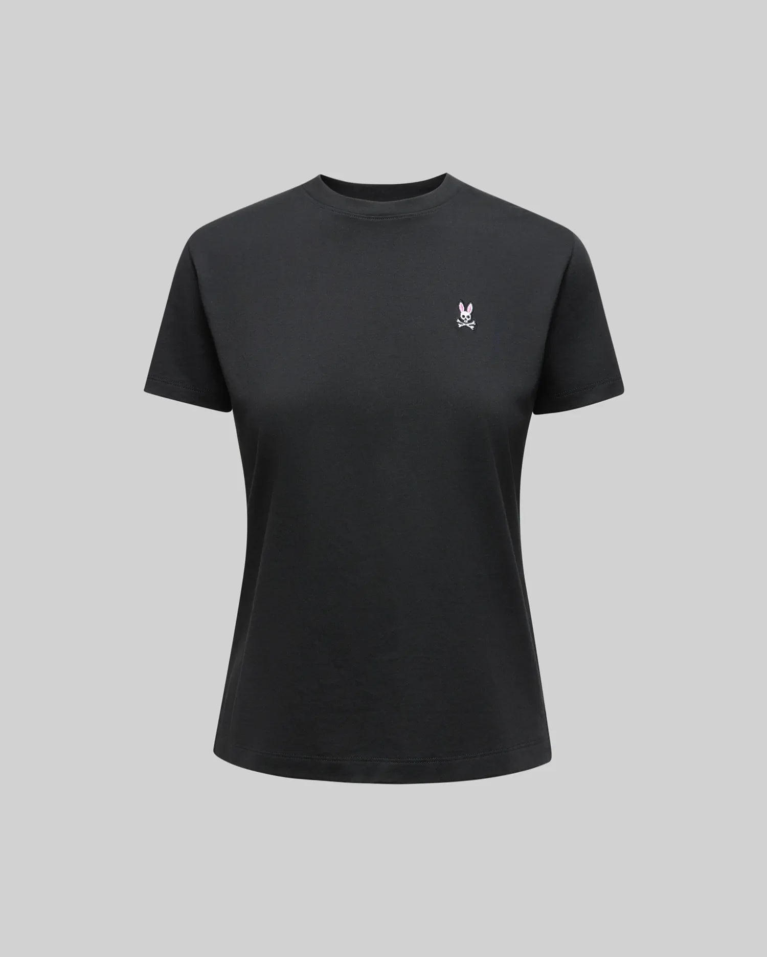 The Psycho Bunny WOMENS CLASSIC TEE - WT0200005 is a plain black Pima cotton shirt with a small white 4k stitch Bunny logo on the left chest, shown on a neutral gray background.