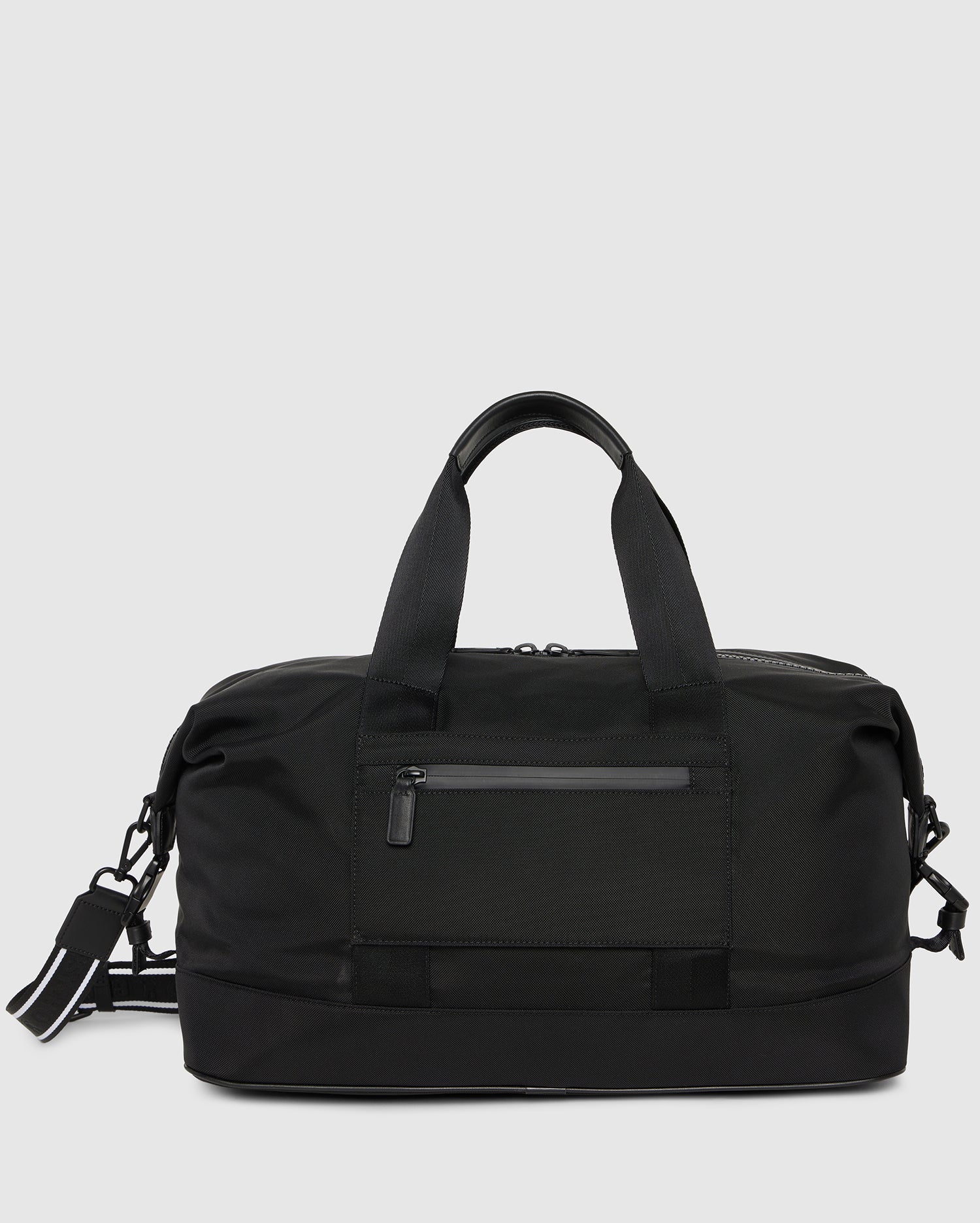The Psycho Bunny MENS WEEKENDER BAG - B6A629Z1BG in sleek black features sturdy handles, an adjustable shoulder strap, a front zippered pocket, and a spacious main compartment—perfect for gym trips or weekend getaways.