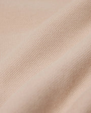Close-up of a beige fabric with a slightly textured surface, displaying a series of gentle horizontal folds. The material appears soft and smooth, suggesting an elevated style and an exceptional on-body feel, perfect for crafting Psycho Bunny's MENS BEDFORD SHIRT JACKET - B6J290B200.